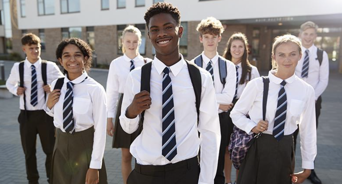 Secondary school students outside a school building